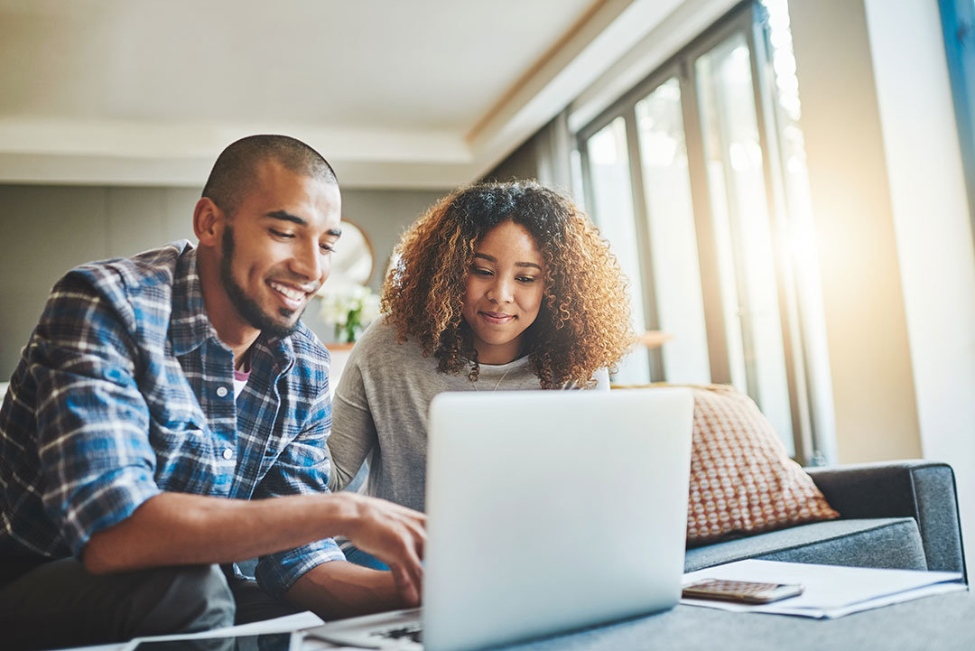 Couple looking at finances on a computer